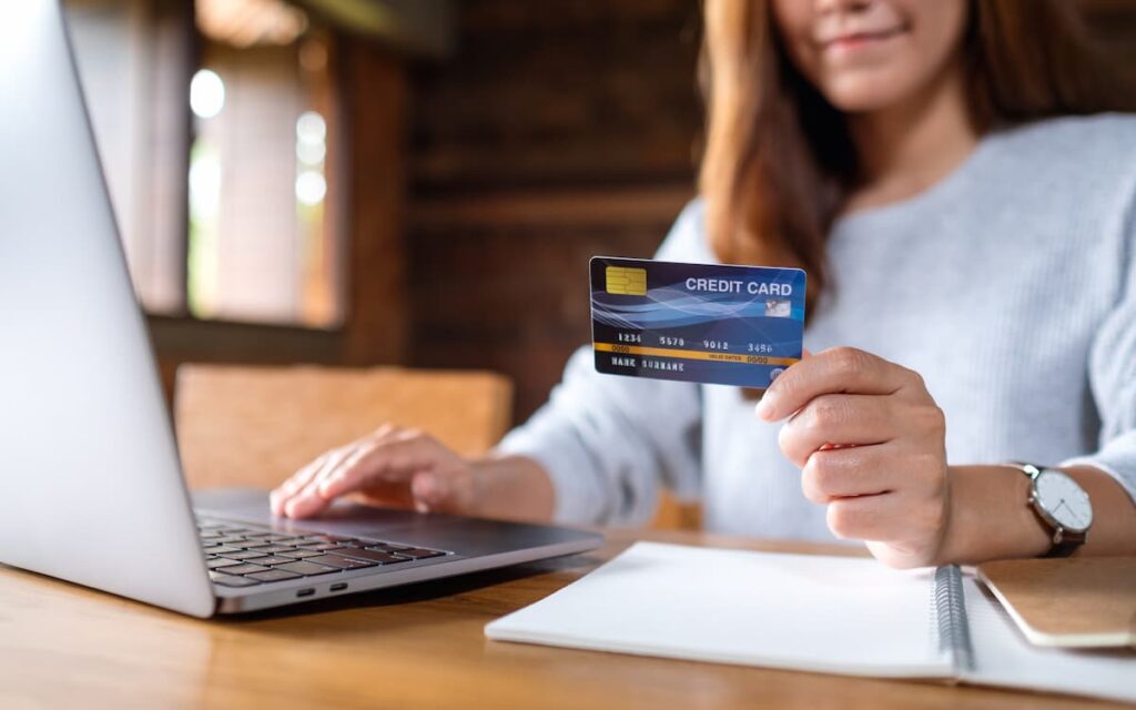 Business woman holding credit card.